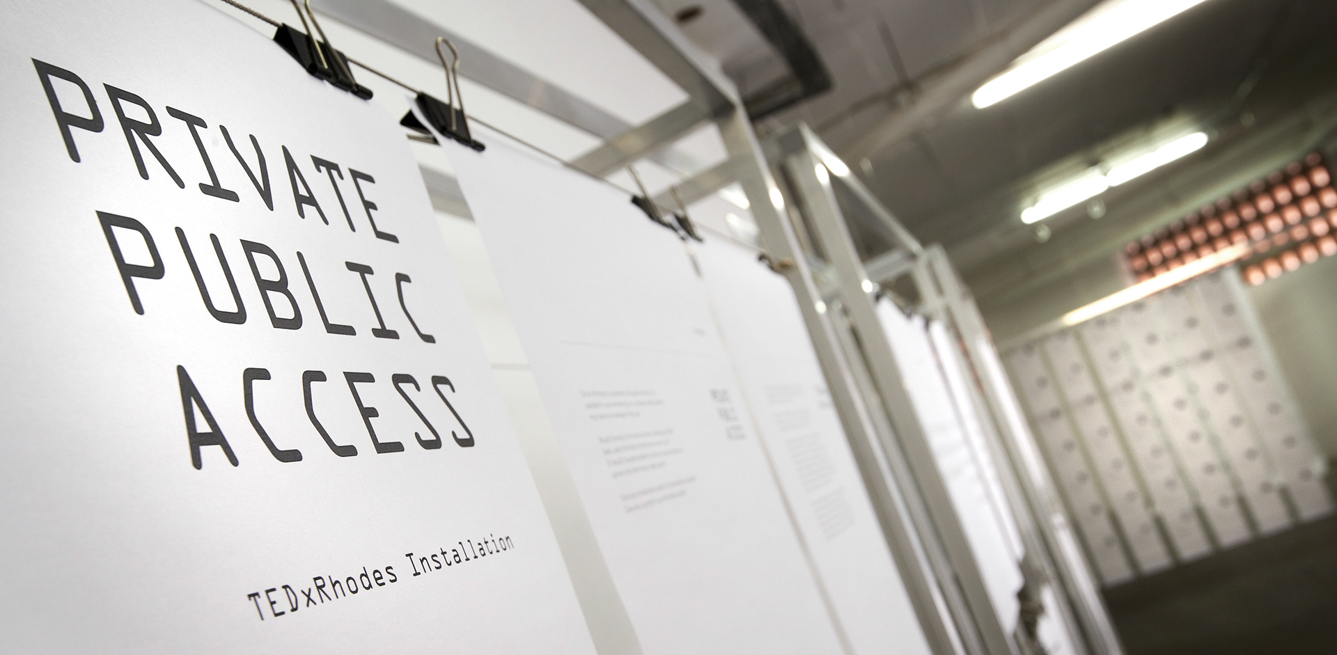 Private Public Access title printed across suspended paper