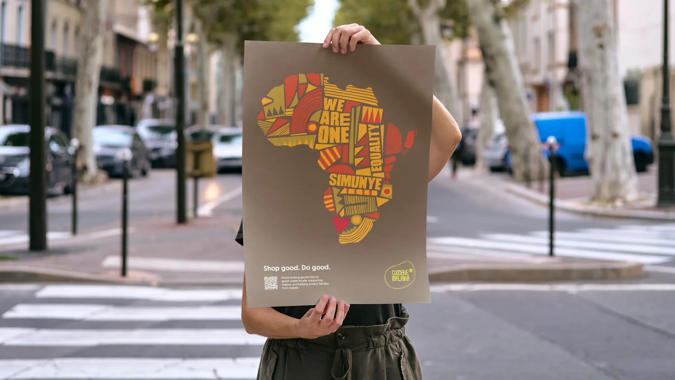 Illustrated African continent campaign poster held on a city street