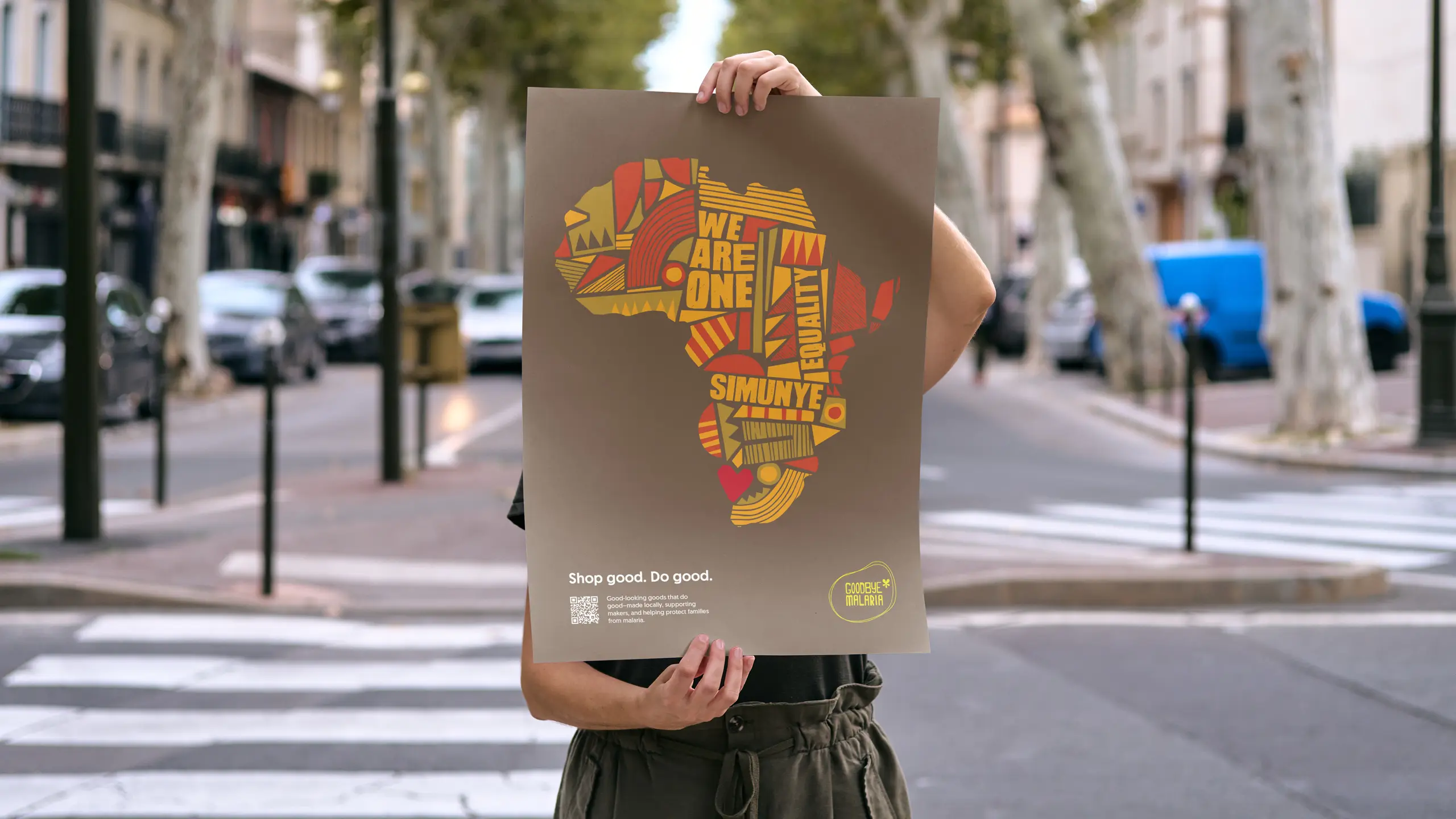 Illustrated African continent campaign poster held on a city street